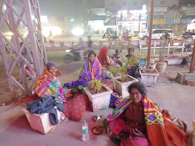 Handing blanket to woman on street